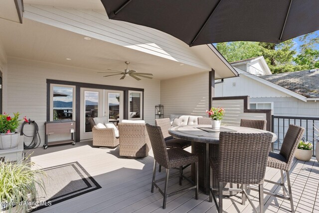 2406 S Silver Beach Rd, Coeur Dalene, ID 83814 - wooden terrace with french doors, outdoor dining space, and a ceiling fan