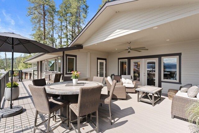 2406 S Silver Beach Rd, Coeur Dalene, ID 83814 - wooden deck featuring ceiling fan and an outdoor hangout area