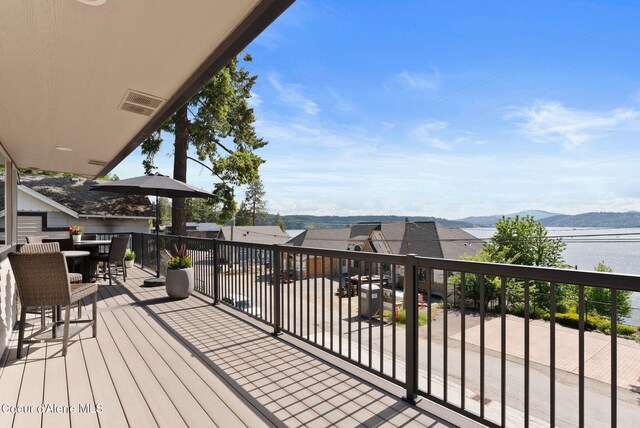 2406 S Silver Beach Rd, Coeur Dalene, ID 83814 - wooden terrace with a water and mountain view