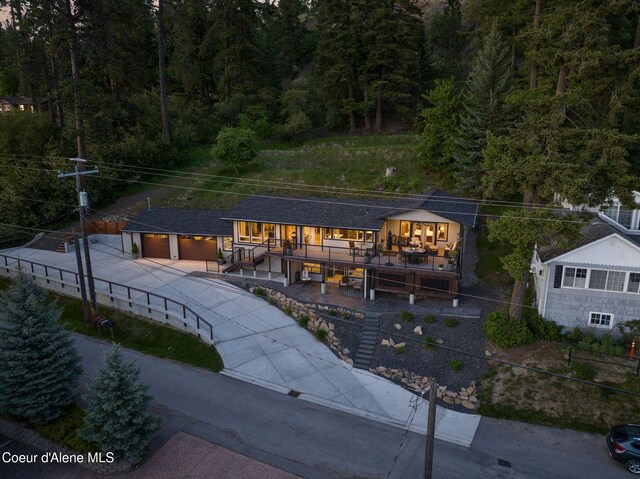 2406 S Silver Beach Rd, Coeur Dalene, ID 83814 - view of front of house with driveway, an attached garage, a wooded view, and stairs