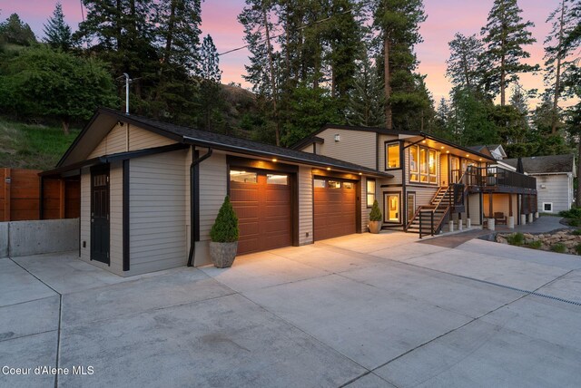 2406 S Silver Beach Rd, Coeur Dalene, ID 83814 - view of front of house featuring stairway, an attached garage, driveway, a deck, and an outdoor structure
