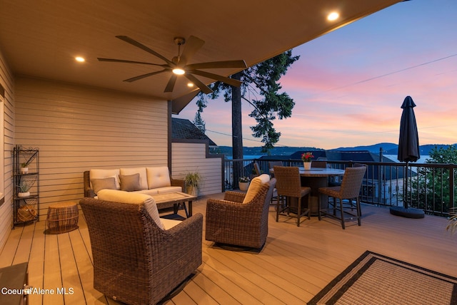 2406 S Silver Beach Rd, Coeur Dalene, ID 83814 - wooden deck with a ceiling fan, outdoor dining space, and an outdoor living space