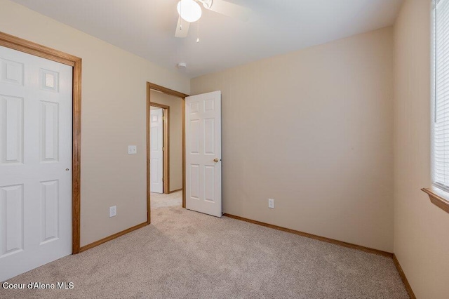 11221 N Crusader St, Hayden, ID 83835 - unfurnished bedroom featuring light carpet, baseboards, and a ceiling fan
