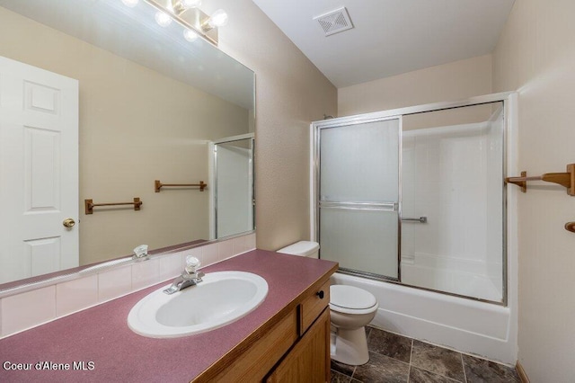 11221 N Crusader St, Hayden, ID 83835 - full bathroom featuring toilet, vanity, and bath / shower combo with glass door