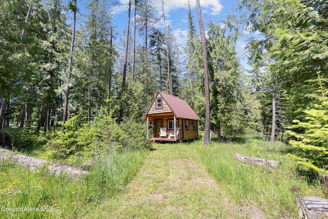 99 Broten Way, Sagle, ID 83860 - view of front of house with metal roof and a forest view
