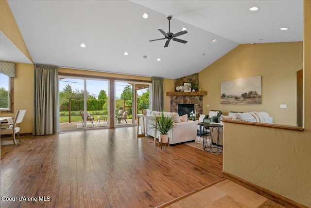 1874 W Polo Green Ave, Post Falls, ID 83854 - living room featuring ceiling fan, a stone fireplace, hardwood / wood-style floors, baseboards, and recessed lighting