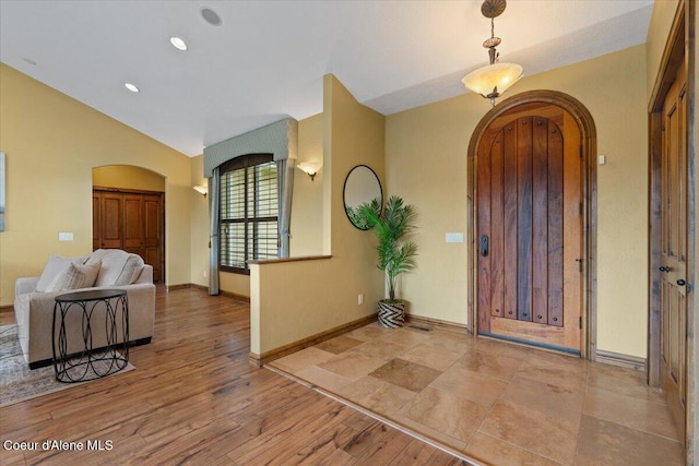 1874 W Polo Green Ave, Post Falls, ID 83854 - entryway with arched walkways, baseboards, wood finished floors, lofted ceiling, and recessed lighting