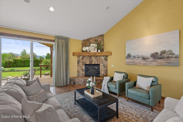 1874 W Polo Green Ave, Post Falls, ID 83854 - living room featuring wood finished floors, vaulted ceiling, and a fireplace