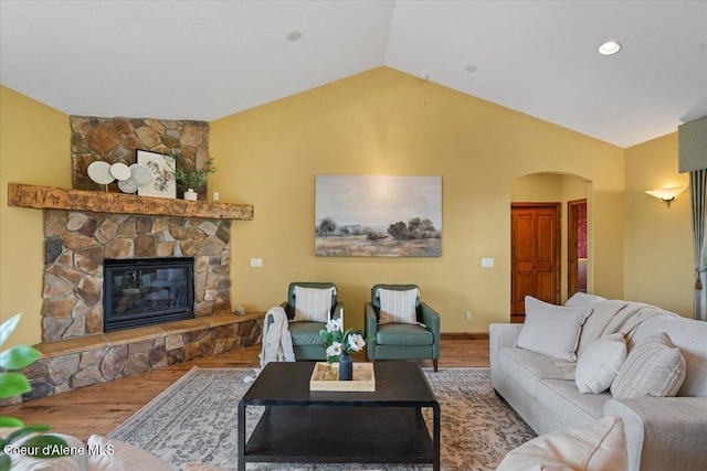1874 W Polo Green Ave, Post Falls, ID 83854 - living room with arched walkways, wood finished floors, lofted ceiling, and a fireplace