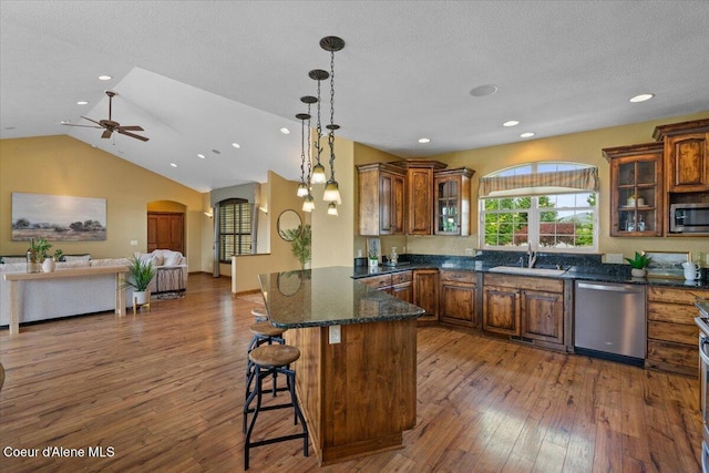 1874 W Polo Green Ave, Post Falls, ID 83854 - kitchen featuring appliances with stainless steel finishes, a sink, brown cabinets, hardwood / wood-style flooring, and recessed lighting
