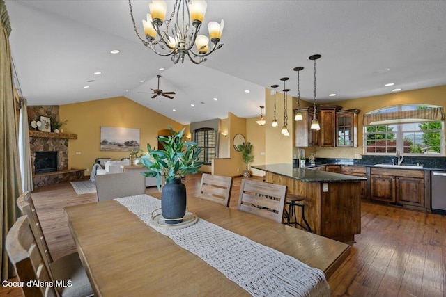 1874 W Polo Green Ave, Post Falls, ID 83854 - dining room with a chandelier, hardwood / wood-style flooring, a ceiling fan, lofted ceiling, and a fireplace