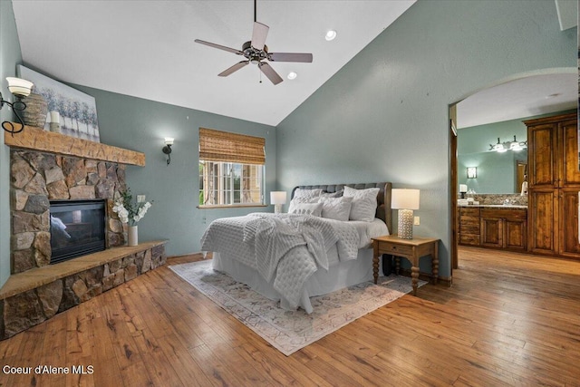 1874 W Polo Green Ave, Post Falls, ID 83854 - bedroom with wood-type flooring, a fireplace, high vaulted ceiling, ensuite bathroom, and a ceiling fan