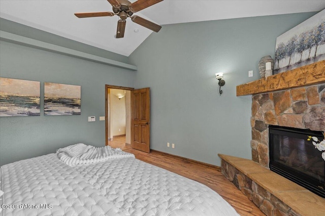 1874 W Polo Green Ave, Post Falls, ID 83854 - bedroom featuring wood finished floors, a fireplace, high vaulted ceiling, baseboards, and a ceiling fan