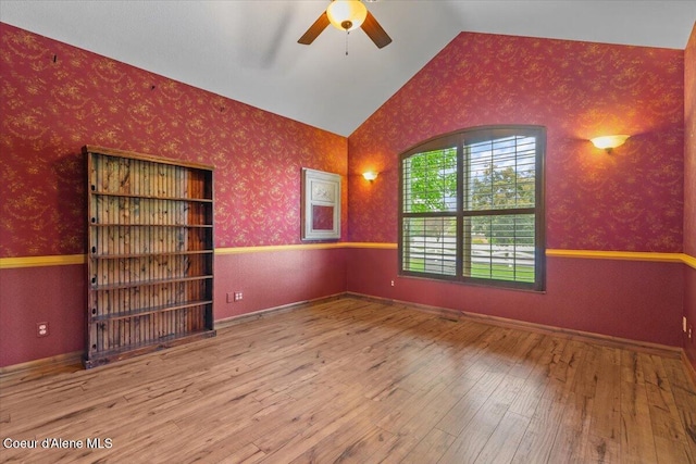 1874 W Polo Green Ave, Post Falls, ID 83854 - spare room with a ceiling fan, wallpapered walls, lofted ceiling, and wood-type flooring