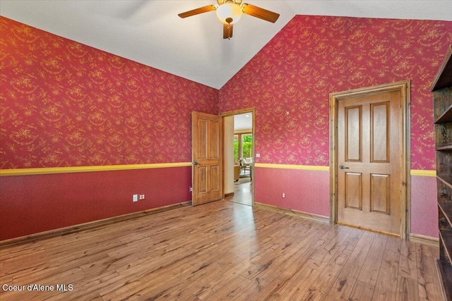 1874 W Polo Green Ave, Post Falls, ID 83854 - unfurnished bedroom featuring lofted ceiling, wood-type flooring, and a ceiling fan