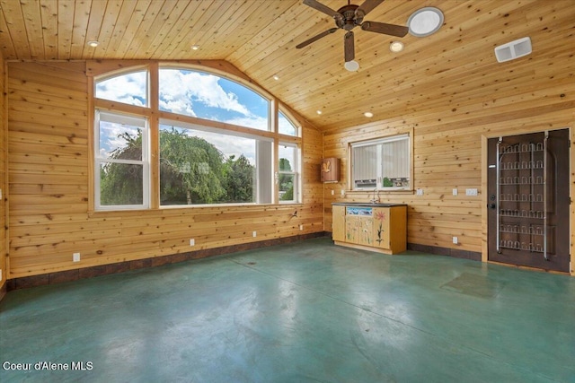 1874 W Polo Green Ave, Post Falls, ID 83854 - unfurnished living room featuring vaulted ceiling, concrete flooring, a ceiling fan, wooden walls, and wood ceiling