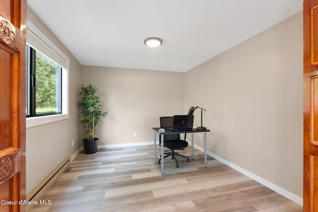 176 Swan Shores Dr, Sagle, ID 83860 - home office with a baseboard radiator, light wood-type flooring, and baseboards