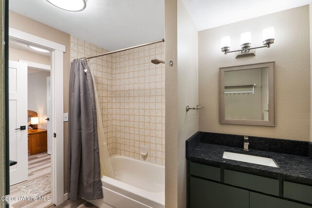 176 Swan Shores Dr, Sagle, ID 83860 - bathroom with shower / bath combo with shower curtain, vanity, and wood finished floors