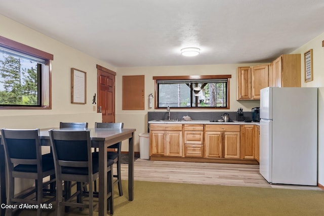 176 Swan Shores Dr, Sagle, ID 83860 - kitchen with freestanding refrigerator, plenty of natural light, light countertops, and light wood-style floors
