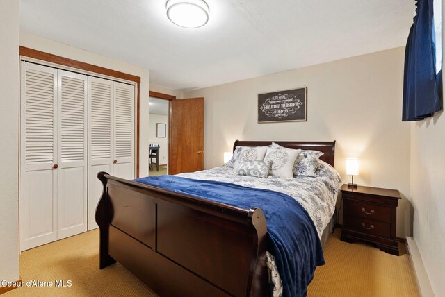 176 Swan Shores Dr, Sagle, ID 83860 - bedroom featuring light carpet, a closet, and baseboards