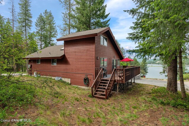 176 Swan Shores Dr, Sagle, ID 83860 - rear view of property with a deck with water view, roof with shingles, and stairway