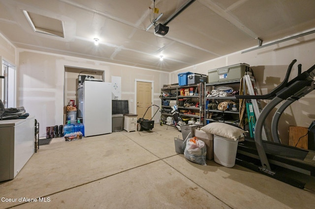 27968 N Timber Ridge Rd, Rathdrum, ID 83858 - garage featuring a garage door opener and freestanding refrigerator