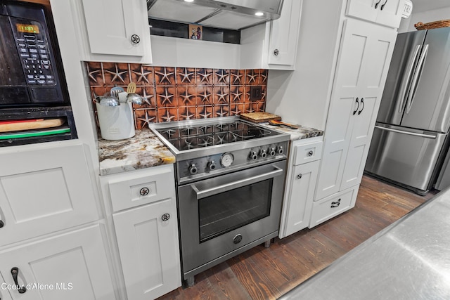 5005 W Cougar Estates Rd, Coeur Dalene, ID 83814 - kitchen featuring appliances with stainless steel finishes, dark wood finished floors, white cabinets, decorative backsplash, and under cabinet range hood