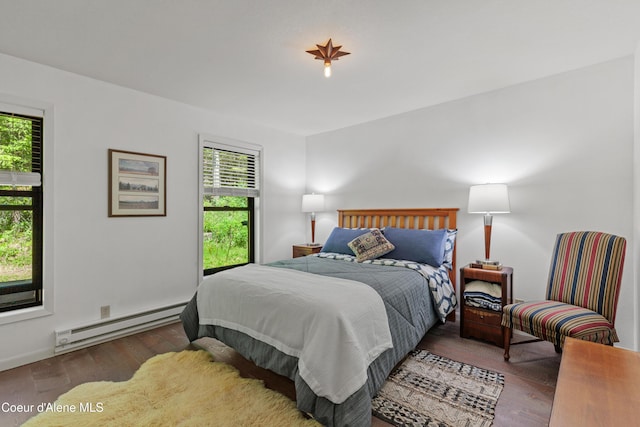 5005 W Cougar Estates Rd, Coeur Dalene, ID 83814 - bedroom with a baseboard heating unit, multiple windows, and wood finished floors