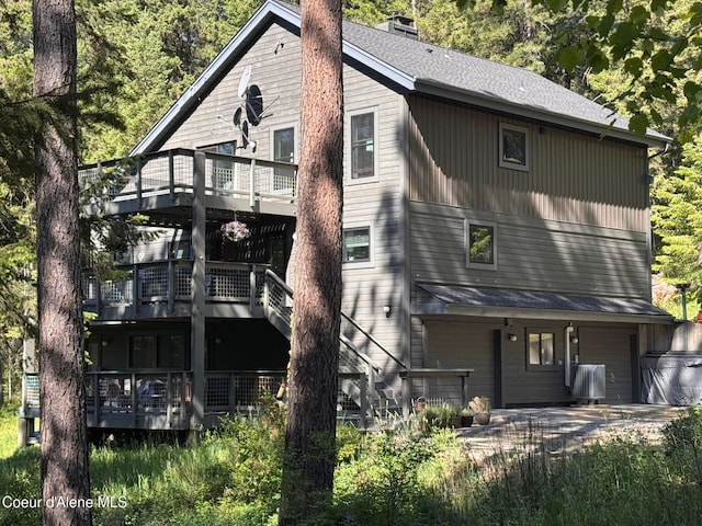 5005 W Cougar Estates Rd, Coeur Dalene, ID 83814 - back of house featuring a balcony, a deck, and a chimney