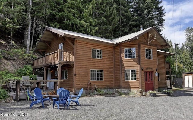 19118 St Joe River Rd, Calder, ID 83808 - rear view of house with a fire pit, a balcony, and metal roof