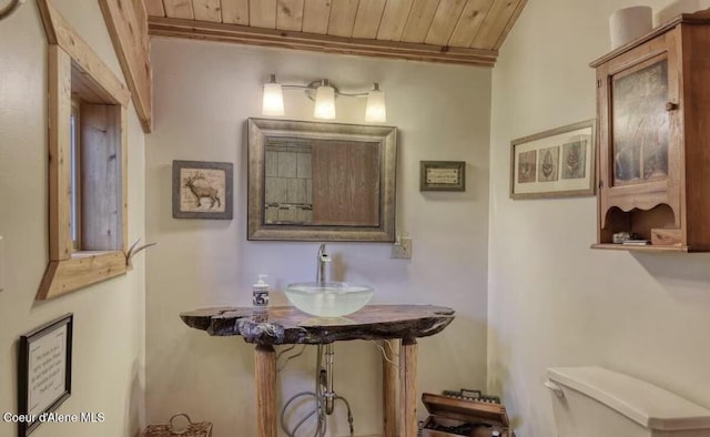 19118 St Joe River Rd, Calder, ID 83808 - bathroom featuring wooden ceiling, toilet, and a sink