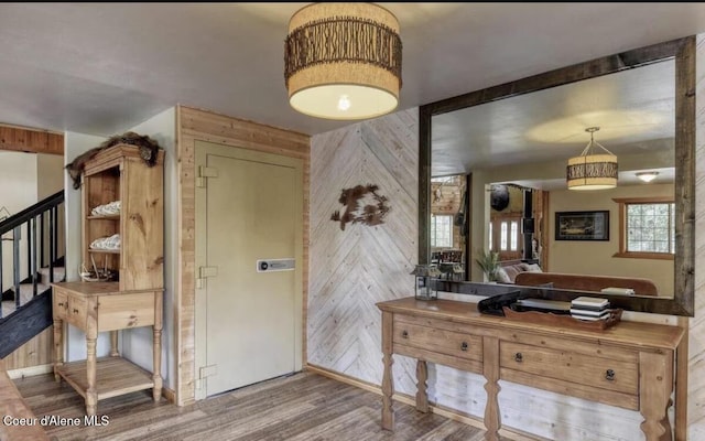 19118 St Joe River Rd, Calder, ID 83808 - foyer featuring wooden walls, wood finished floors, and stairs