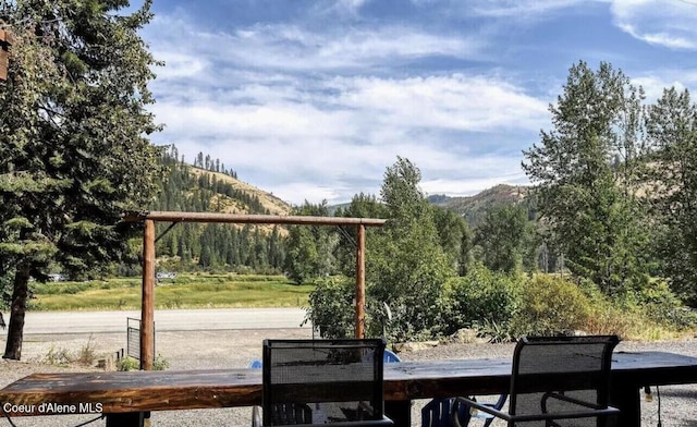 19118 St Joe River Rd, Calder, ID 83808 - wooden deck featuring a mountain view and a wooded view
