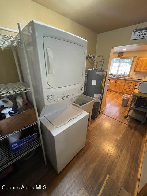 19118 St Joe River Rd, Calder, ID 83808 - washroom with electric water heater, stacked washing machine and dryer, and light wood-style flooring