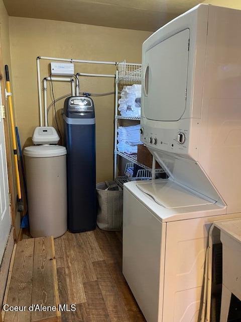 19118 St Joe River Rd, Calder, ID 83808 - laundry area featuring stacked washer / drying machine and wood finished floors