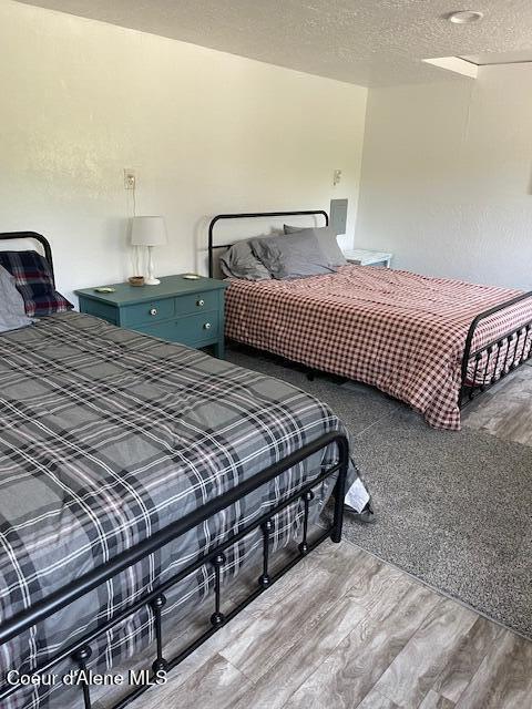 19118 St Joe River Rd, Calder, ID 83808 - bedroom featuring wood finished floors and a textured ceiling