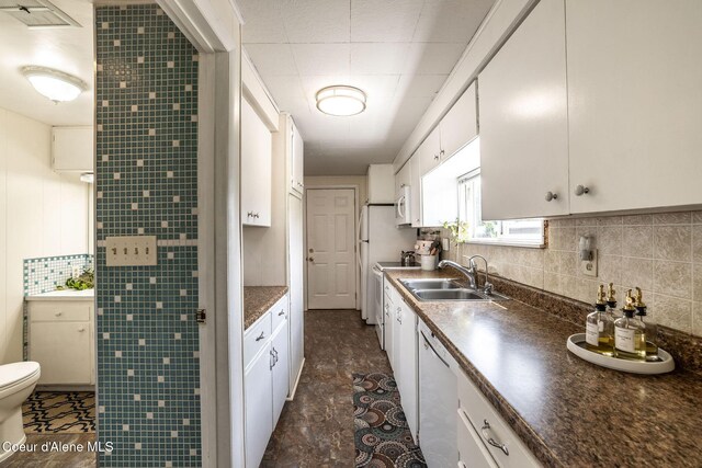 13744 N Hauser Lake Rd, Hauser, ID 83854 - kitchen with a sink, white cabinets, dark countertops, backsplash, and white appliances
