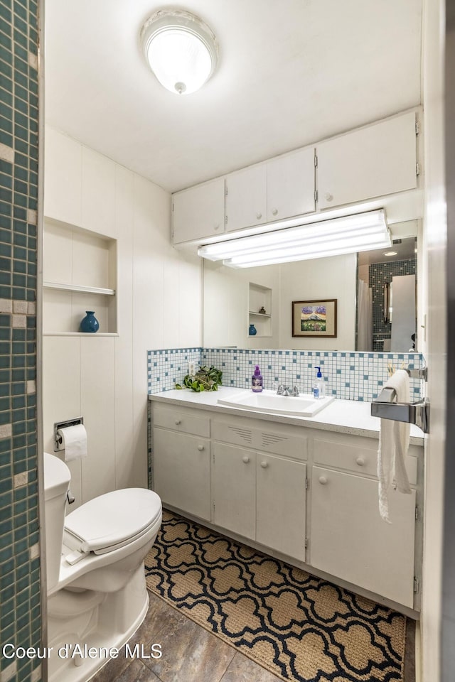 13744 N Hauser Lake Rd, Hauser, ID 83854 - bathroom with vanity, toilet, and tasteful backsplash