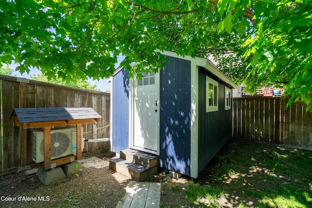 1800 N Willamette Dr, Post Falls, ID 83854 - view of shed featuring entry steps, a fenced backyard, and a cooling unit