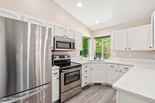 1800 N Willamette Dr, Post Falls, ID 83854 - kitchen featuring stainless steel appliances, a sink, vaulted ceiling, white cabinets, and recessed lighting