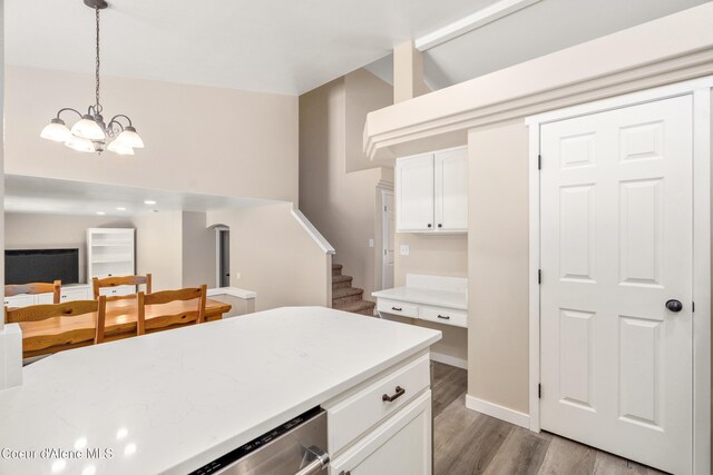 1800 N Willamette Dr, Post Falls, ID 83854 - kitchen featuring a chandelier, light wood-style flooring, white cabinets, decorative light fixtures, and open floor plan