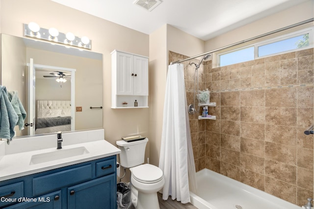 1800 N Willamette Dr, Post Falls, ID 83854 - ensuite bathroom with vanity, tiled shower, toilet, and a ceiling fan