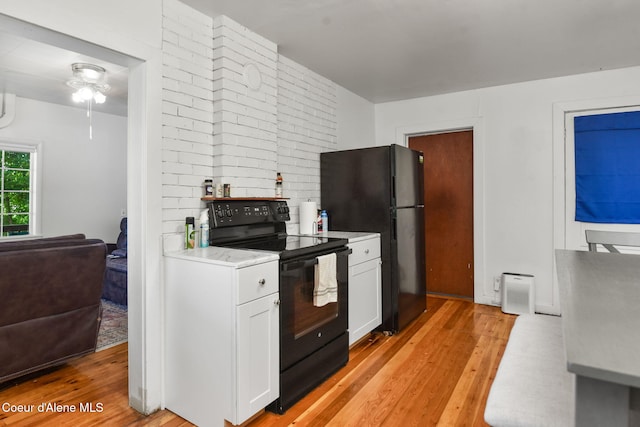108 E Lincoln Ct, Harrison, ID 83833 - kitchen featuring black appliances, light wood-style floors, white cabinets, light countertops, and ceiling fan