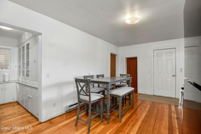 108 E Lincoln Ct, Harrison, ID 83833 - dining space featuring light wood finished floors, baseboard heating, and baseboards