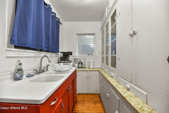 108 E Lincoln Ct, Harrison, ID 83833 - kitchen with light wood-type flooring, a sink, and light countertops