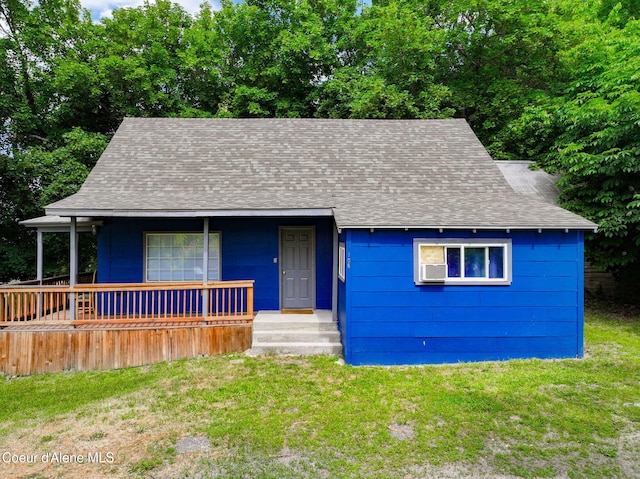 108 E Lincoln Ct, Harrison, ID 83833 - view of front of home featuring roof with shingles, a front yard, covered porch, and cooling unit