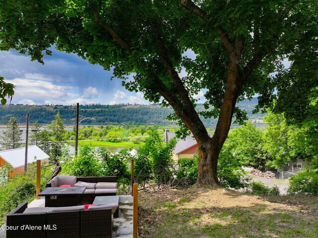 108 E Lincoln Ct, Harrison, ID 83833 - view of yard with a water view, an outdoor living space, and a forest view
