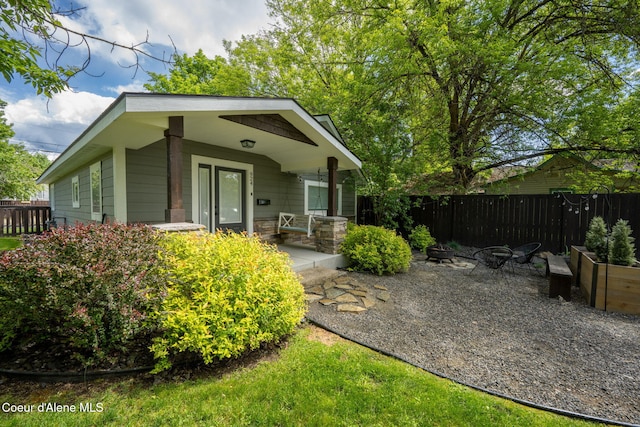924 N 6th St, Coeur Dalene, ID 83814 - back of house featuring an outdoor fire pit and stone siding