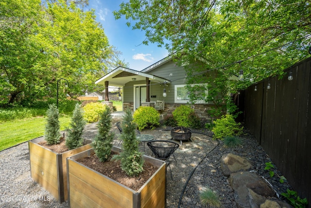 924 N 6th St, Coeur Dalene, ID 83814 - view of patio / terrace featuring a garden and a fire pit