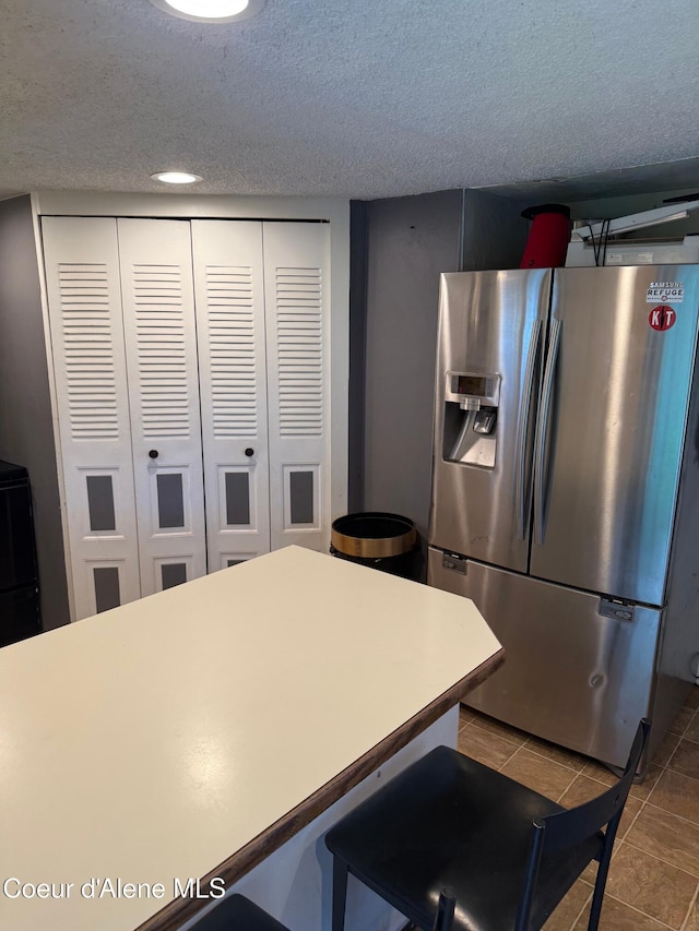 30625 Pastime St, Athol, ID 83801 - kitchen featuring stainless steel fridge, tile patterned floors, a textured ceiling, and recessed lighting